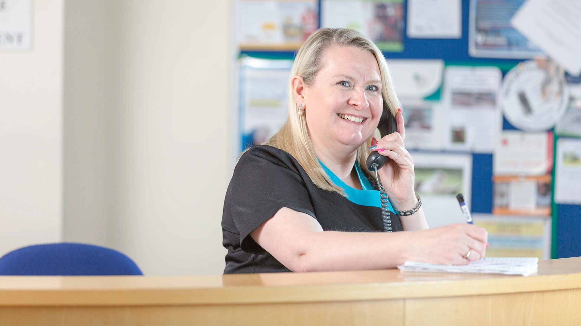 receptionist taking a call in clinic