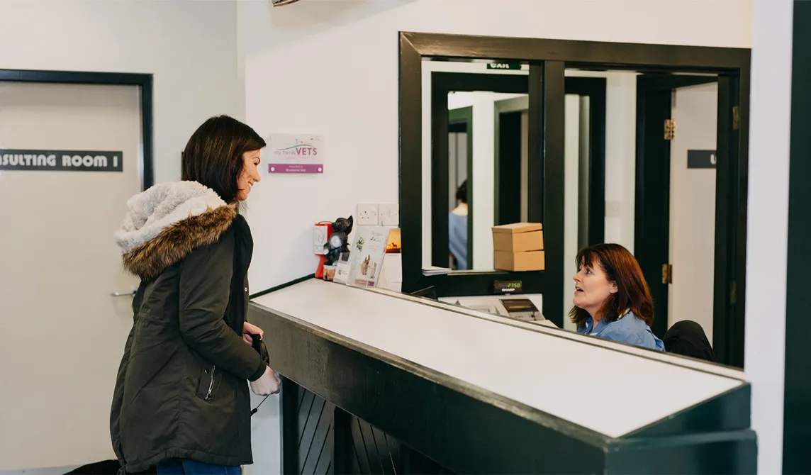 client speaking to a veterinary receptionist