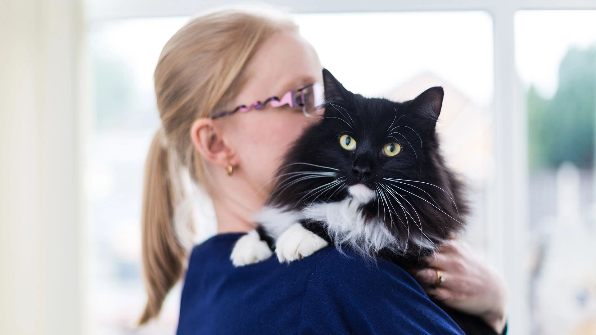 Black and white cat on nurses shoulder