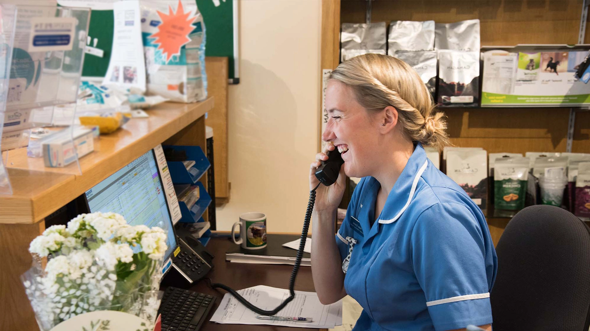 Receptionist on the phone laughing