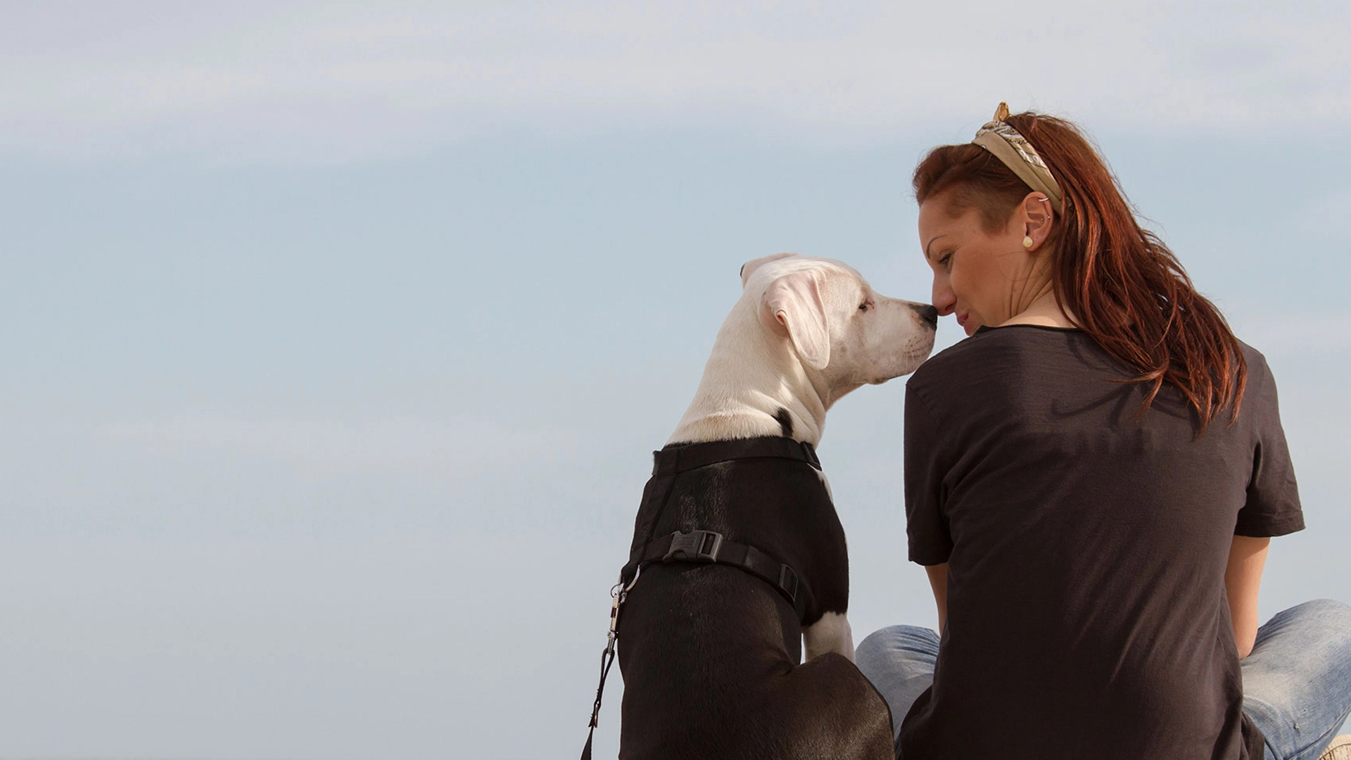 Woman and dog touching noses