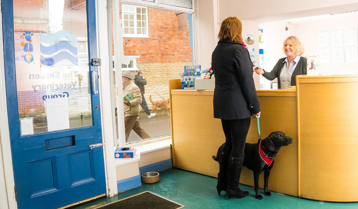 Receptionist greeting customer